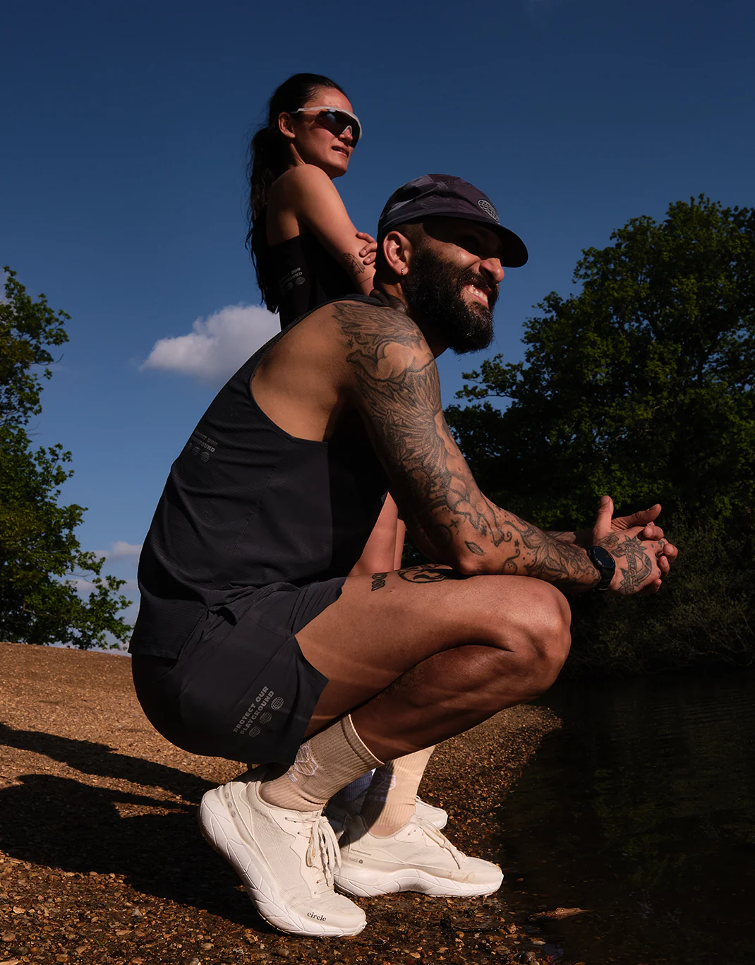 Circle Sportswear athletes resting by a lake in Protect Our Playground kit
